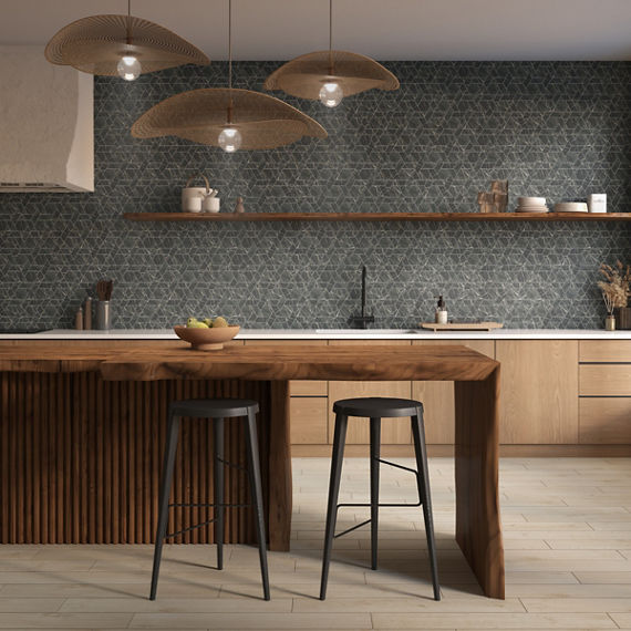 Kitchen with gray marble look mosaic on backsplash, wooden island, and gray barstools.