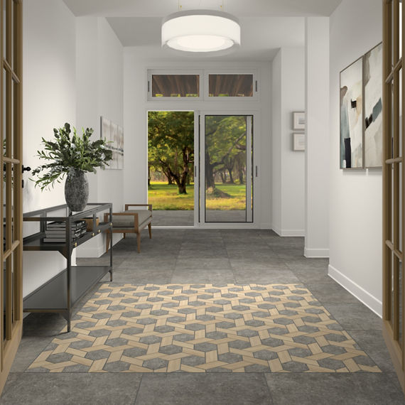 Entry space with gray stone look tile on floor, gray mosaic tile in center of floor, white walls, and wood accents.