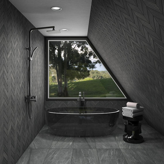Bathroom with dark gray stone look rectangle floor tile, black bathtub, black chevron wall tile, and black accents.