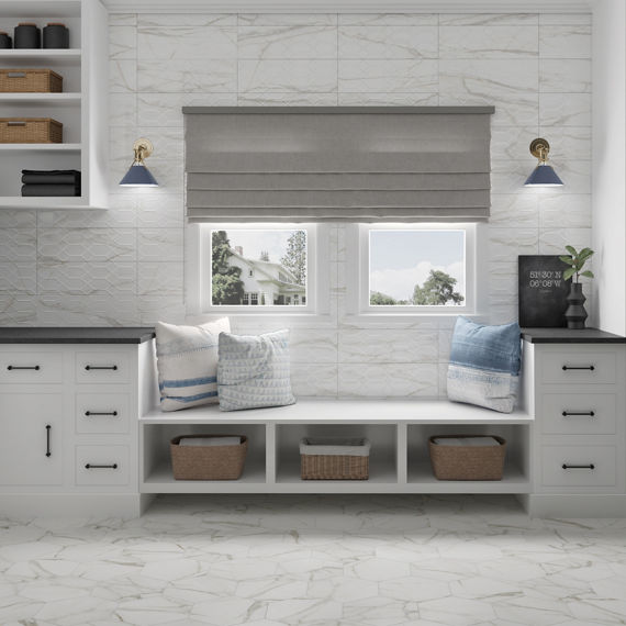 Room with white rectangle marble look floor tile, white rectangle wall tile with 3d design, white cabinets, and white rectangle tile on walls.