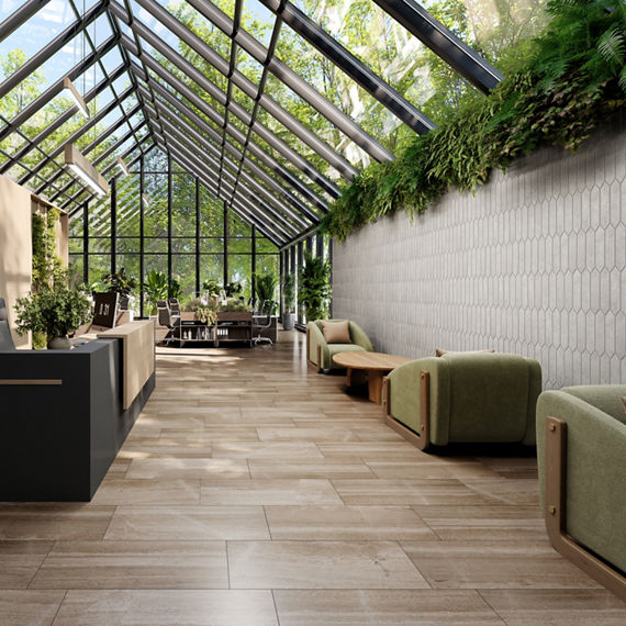 Shared office space with glass ceiling showing greenery, wood look rectangle floor tile, white stone look picket tile on side wall, green sitting chairs, and wood accents.