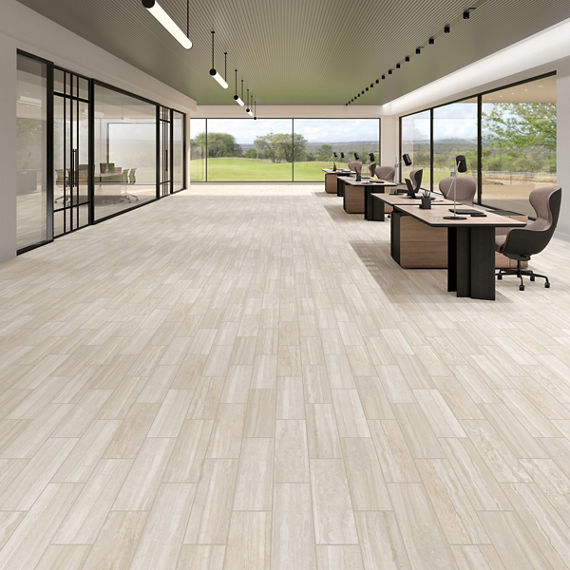 Office space with beige stone look floor tile, wooden desks, and large windows on walls.