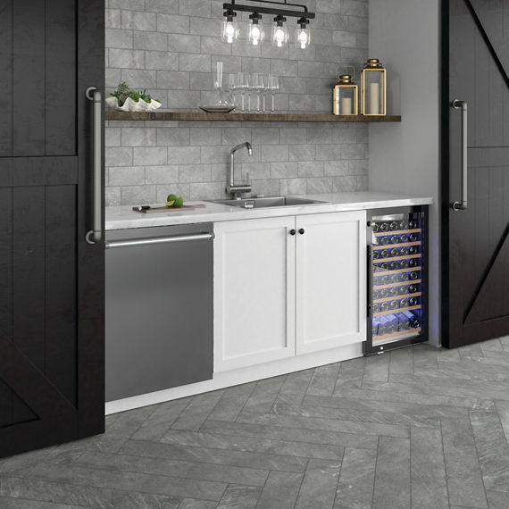 Kitchen with gray rectangle stone look tile on backsplash, gray stone look rectangle tile on floor, and white cabinets.