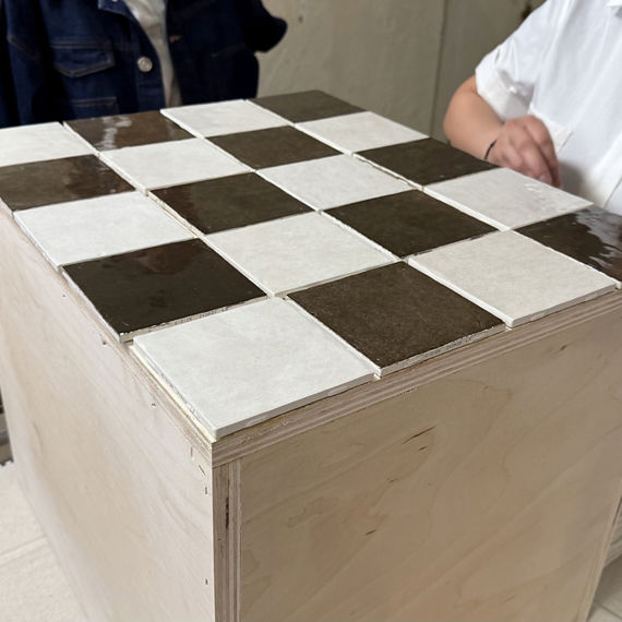 White and brown square tiles placed to test fit table.