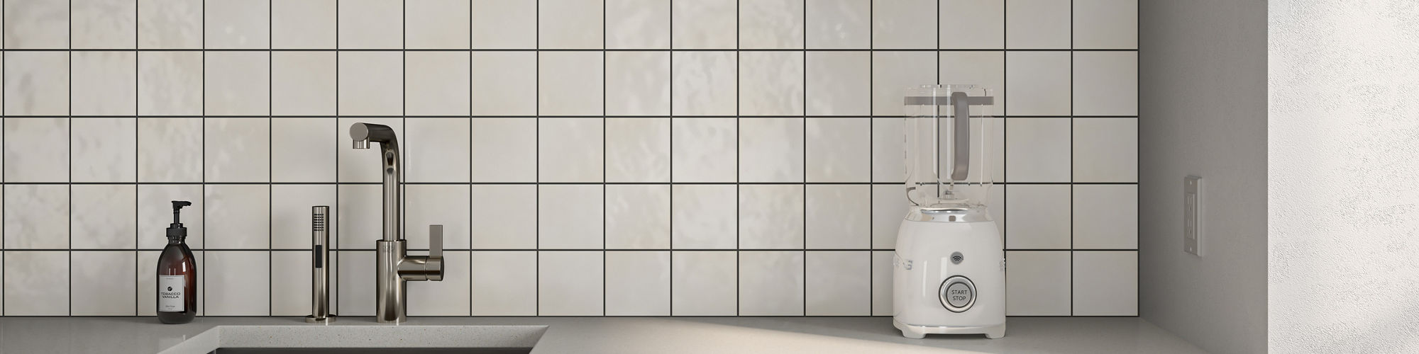 Kitchen with brown and white cabinets, blender on white countertop, and square white wall tile on backsplash.