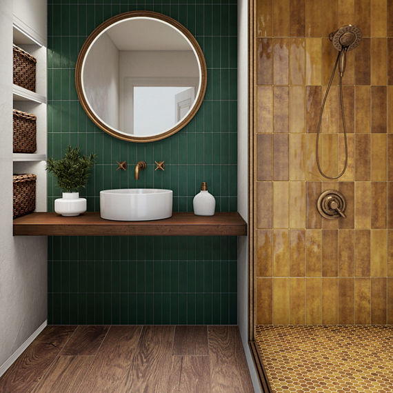Bathroom with green rectangle tile on back wall, yellow subway tile on shower wall, yellow hexagon mosaic tile on shower floor, wood look rectangle floor tile, wood counter, white sink, and gold accents.
