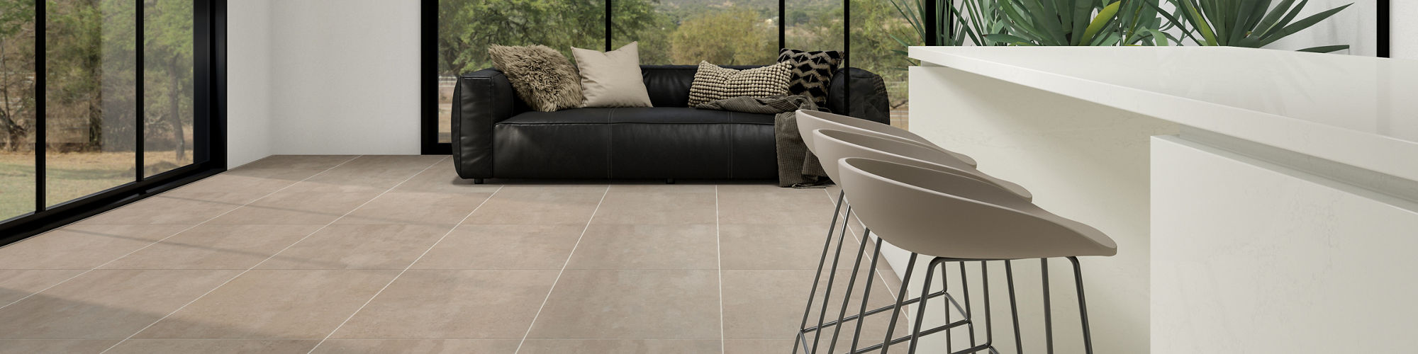 Living area with white bar, dark beige rectangle concrete look floor, three gray bar chairs, and a black couch.