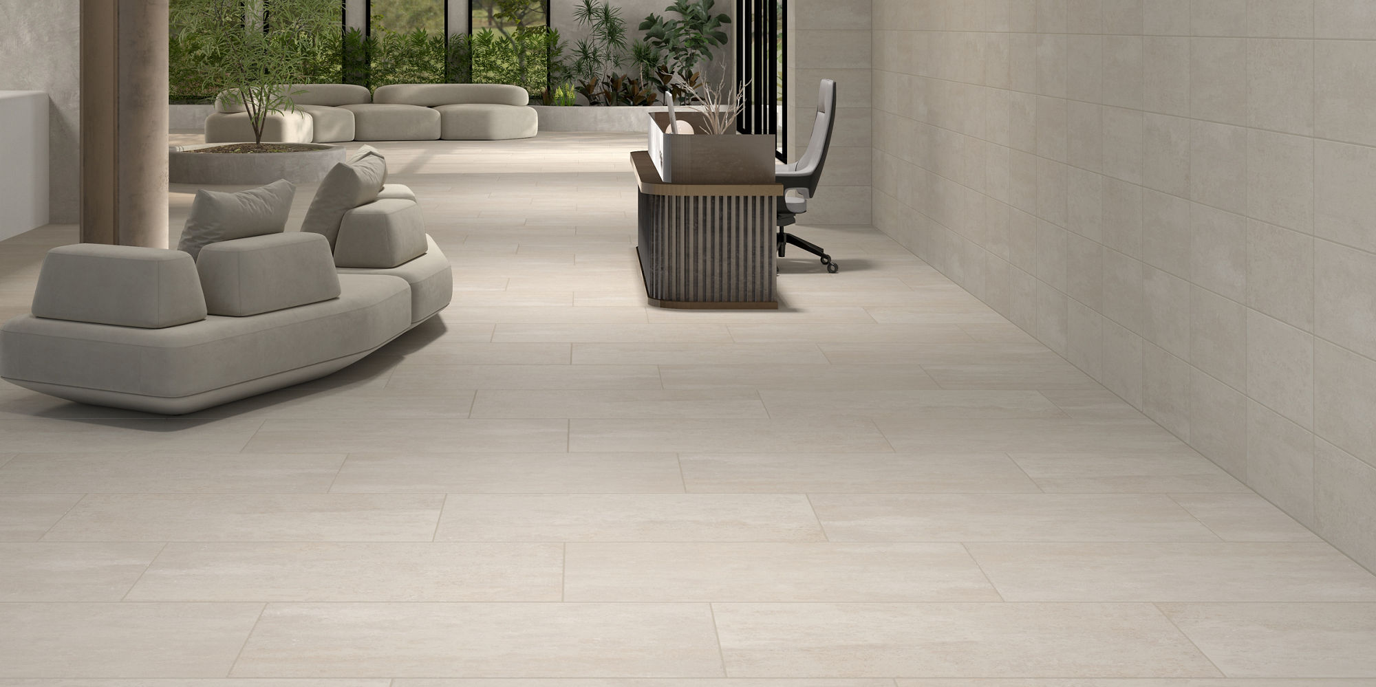 Waiting room with light beige rectangle concrete look floor tile, light beige rectangle concrete tile on walls, two gray couches, and wood accents.