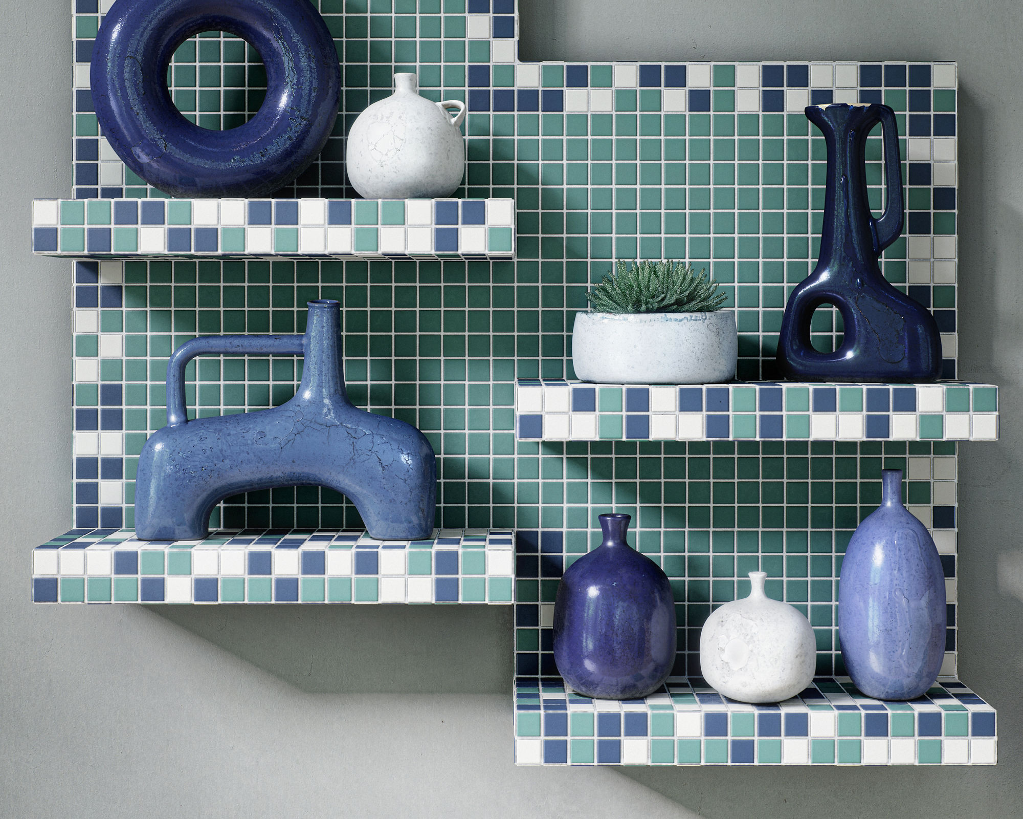 A set of sculptural ceramic vases is displayed on stepped wall shelves covered in small square tiles. The tiles form a geometric pattern in shades of blue, teal, and white against a neutral wall. The vases vary in shape, including circular, elongated