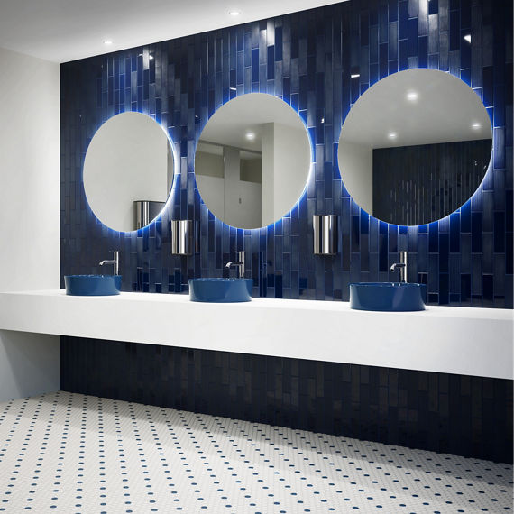 Bathroom with navy blue rectangle tile on right wall, fluted navy rectangle tile on right wall, and white penny round mosaic on floor.