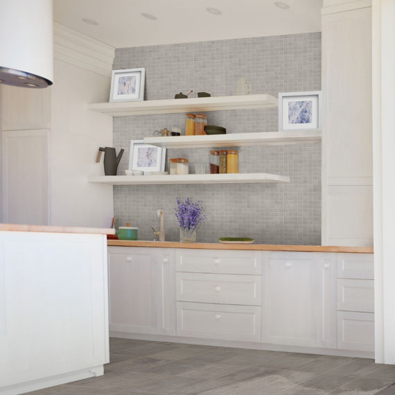 Kitchen with gray mosaic on back wall, floating shelves, white walls and cabinets, and gray wood look floor.