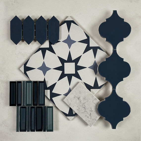 This flatlay contains a concrete look tile accented by an encaustic tile, arabesque accent tile, marble accent tile, picket mosaic, and a glass look mosaic.