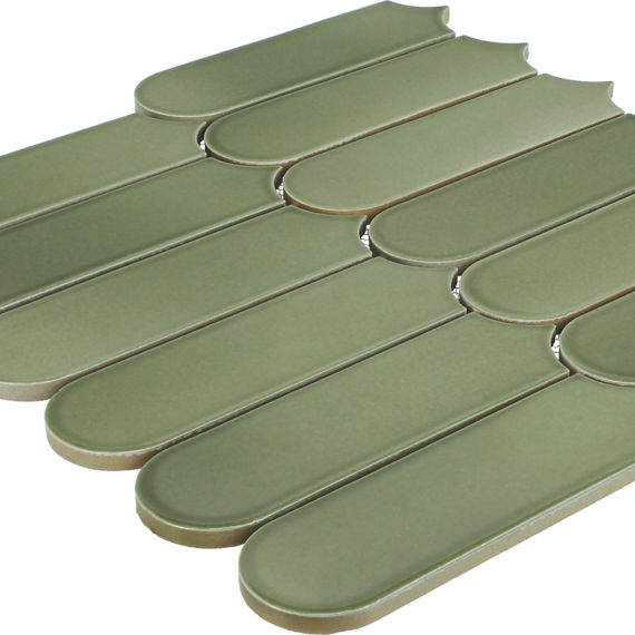 A sheet of elongated green ceramic tiles is arranged in an overlapping scallop pattern. Each tile has rounded ends and a subtle matte finish, creating a sleek contemporary look. The tiles are mounted together as a mosaic sheet, ready for installation