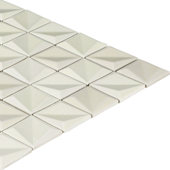 A sheet of white geometric tiles is arranged in a neat grid pattern. Each tile features a raised pyramid shape that creates a three-dimensional effect. The tiles are shown on a plain white background, emphasizing their glossy finish and angular desig