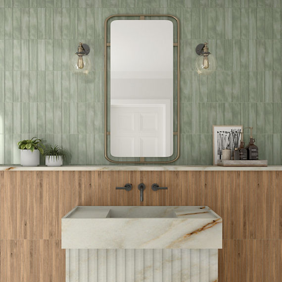 Natural quartzite bathroom vanity with wood look tile and mint green tile backsplash, wall mounted faucet, natural quartzite shelf, framed mirror and globe lighting.