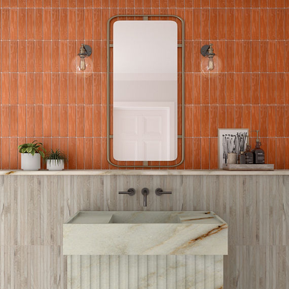 Bathroom with orange rectangle tile on top half of wall, light wood rectangle tile on bottom half of wall, and white marble look sink