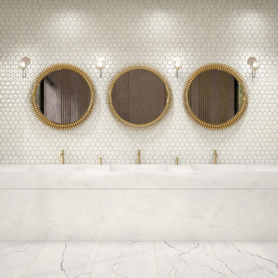 Bathroom with three sinks, white countertop, and a white pyramid hexagon mosaic on the back wall.
