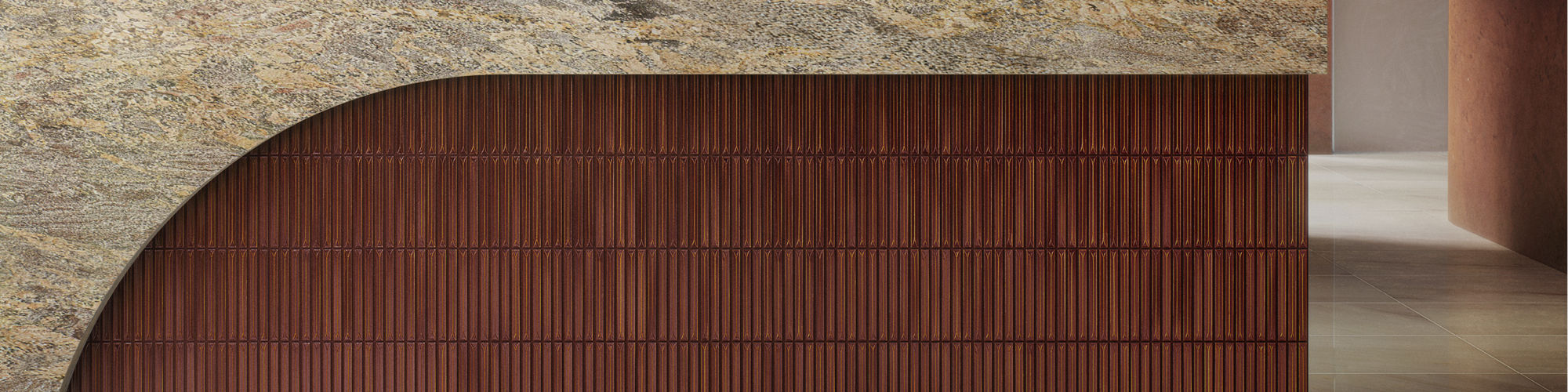 Warm terracotta vertical tile cladding on a curved reception desk in a commercial space