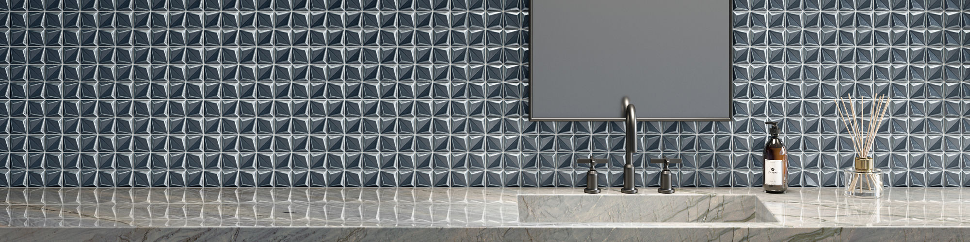 Bathroom with gray countertop, tall mirror, and a blue floret mosaic on the back wall.
