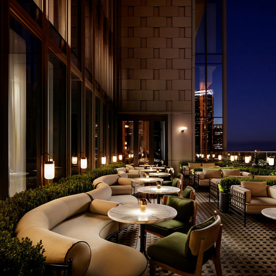 Rooftop restaurant with a white concrete look porcelain slab floor tile custom cut into mosaic, and a black metal look porcelain slab floor tile custom cut into a mosaic, and a concrete look white paver floor tile.