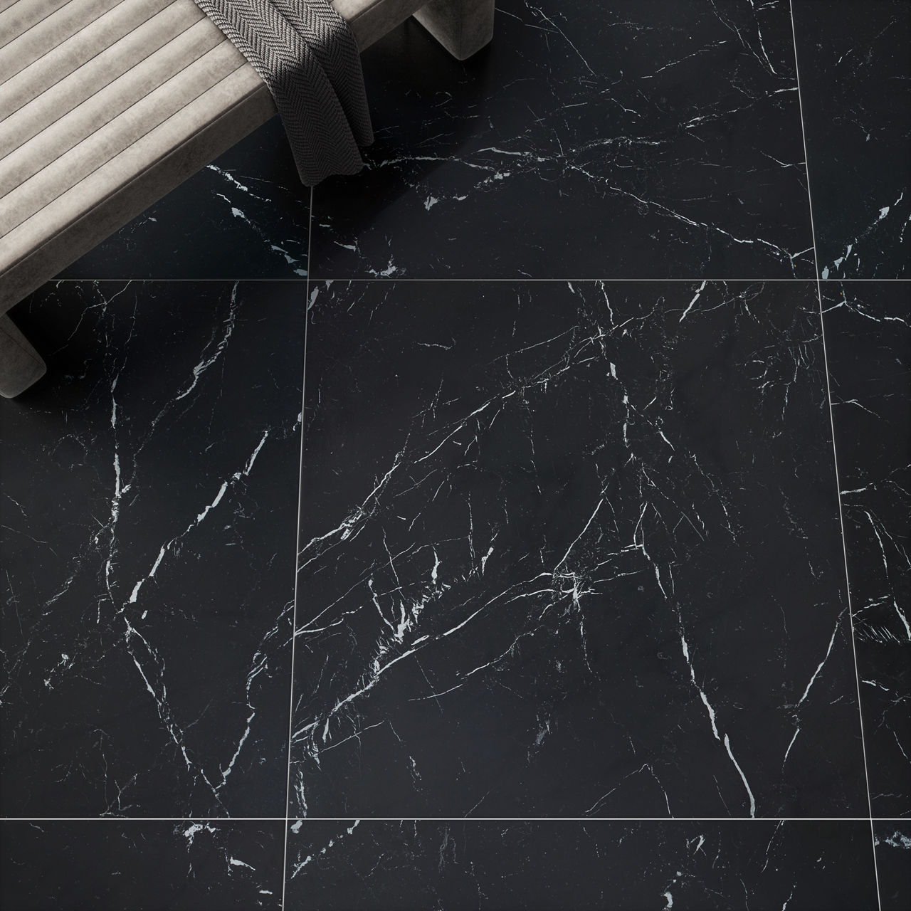 Overhead view of beige bench. gray scarf, and black marble look square floor tile.