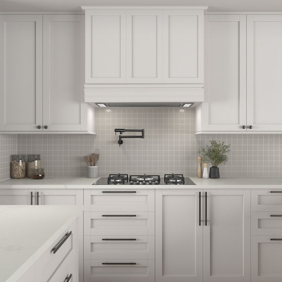 Kitchen with white cabinets, white countertop, and gray square mosaic tile on backsplash.