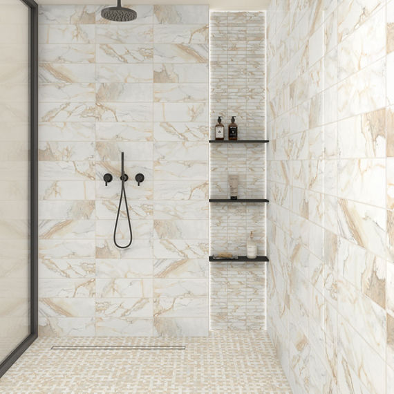 Shower with white marble look rectangle tile on walls, white marble look basketweave mosaic on floor, and black accents.