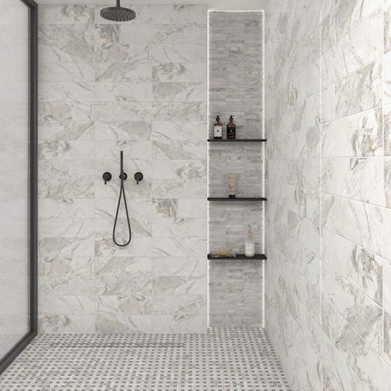 Shower with white marble look rectangle tile on walls, white marble look rectangle mosaic in shower niche, and white marble look basketweave mosaic on shower floor.