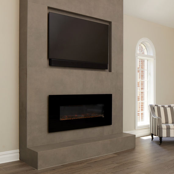Newly renovated living room with floor tile that looks like wood, fireplace with porcelain slab that looks like metal facade and mounted flat-screen TV.