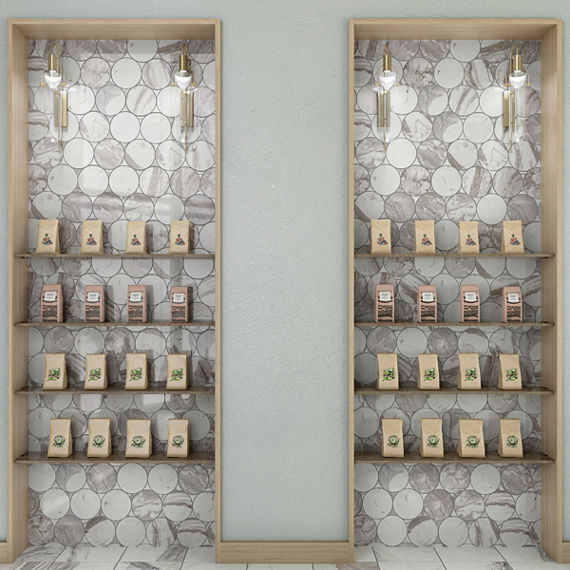 Tea shop with white marble look circle mosaic behind shelves, light walls, and light wood shelves.