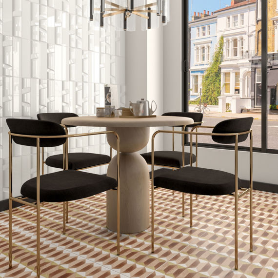 Dining room with rust, peach, and white decorative floor tile, white glossy dimensional wall tile, and a wood table with four chairs.