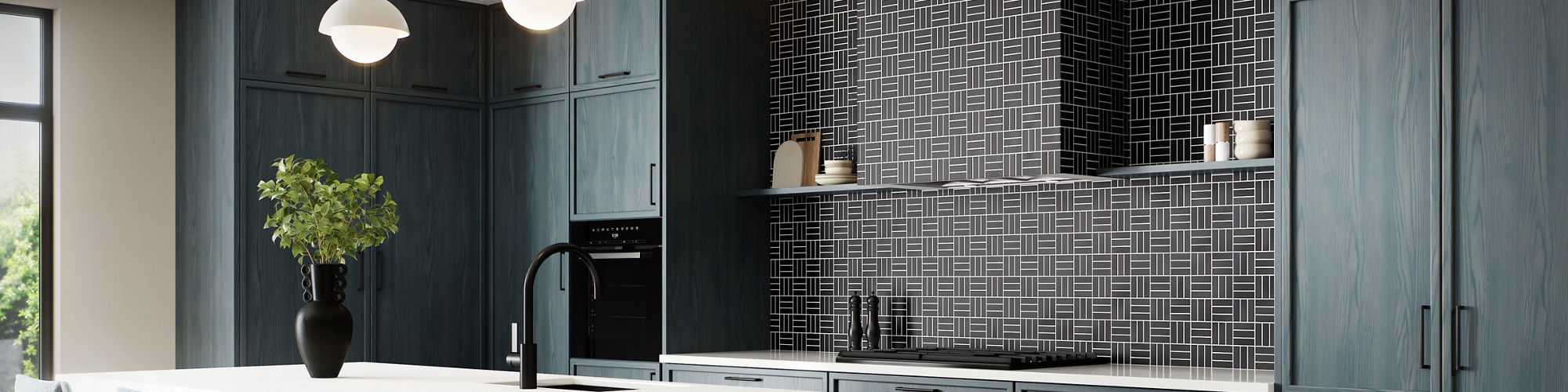 Kitchen with gray stone look square floor tile, blue cabinets, white monochromatic counter and island, blue chairs at island, and black weave mosaic on backsplash.