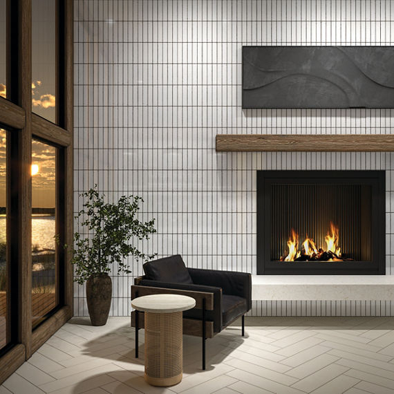 Living room with white metallic look subway tile on back wall, white rectangle floor tile in herringbone pattern, black sitting chair, and a lit fireplace.