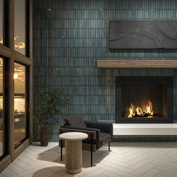 Living room with blue metallic look subway tile on back wall, white rectangle floor tile in herringbone pattern, black sitting chair, and a lit fireplace.