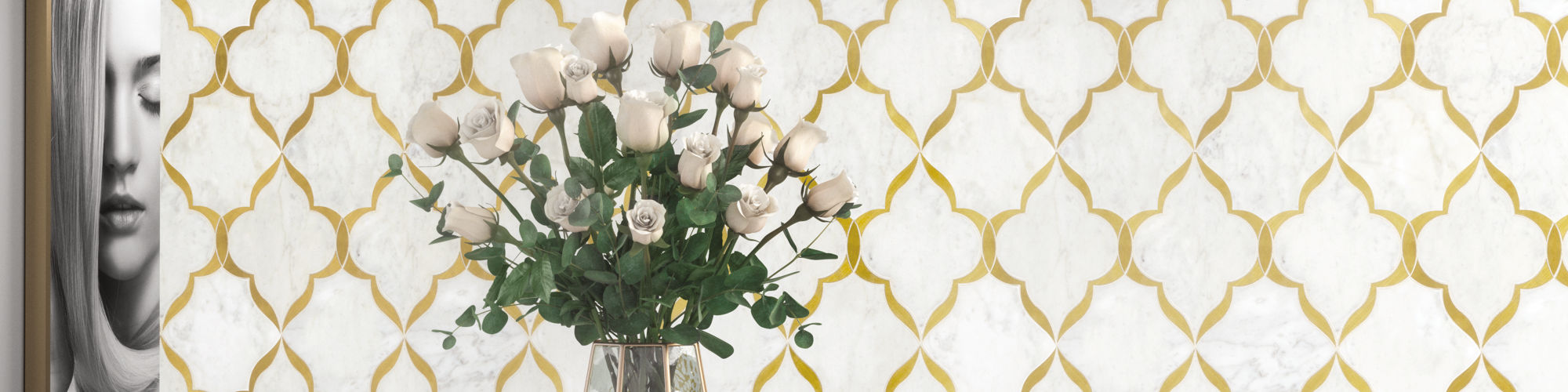 A contemporary kitchen features a striking gold and white geometric tile wall as its focal point. The space is accented by a marble countertop, a vase of white roses, and modern pendant lighting. A monochrome portrait adds an artistic touch to the se