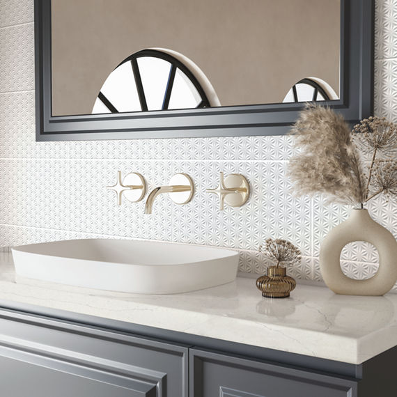 Bathroom sink with white countertop, gray cabinets, and a white 3D rectangle tile on backsplash.