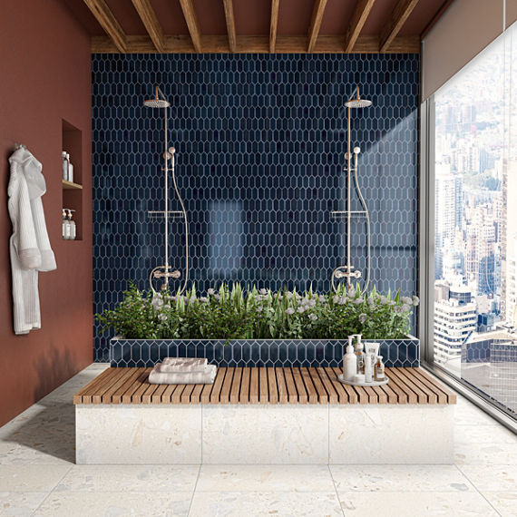 Shower with orange wall, wooden ceiling, white floor tile, two shower heads, and a blue picket mosaic on shower wall.
