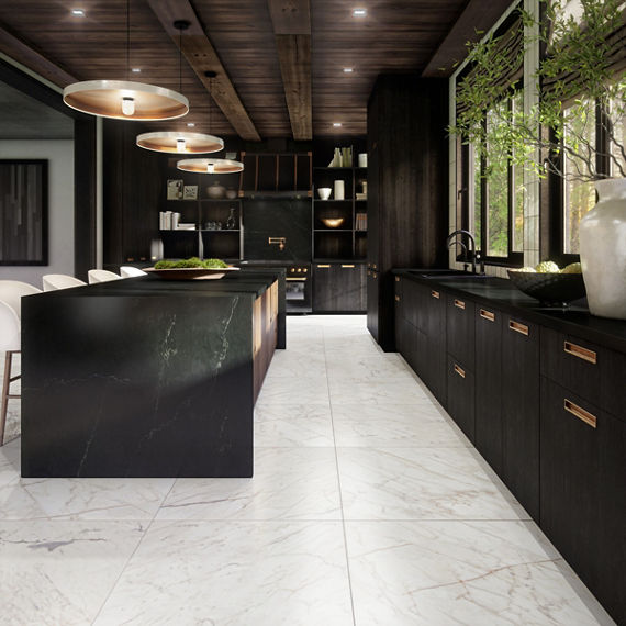 Kitchen with black marble look slab countertops, black cabinets, and white marble look floor tile.