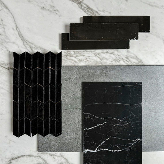 This flatlay contains white marble look square tile, black chevron mosaic, black marble slab, gray stone look rectangle tile, and black rectangle wall tile.