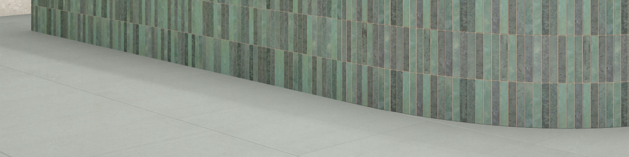 Coffee and pastry shop with white marble look quartz countertop, teal mosaic tile counter base, off white terrazzo look wall tile and gray floor tile.