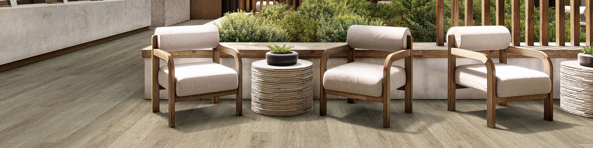 A spacious hotel lobby features contemporary wood flooring and vertical wooden slats as design elements.