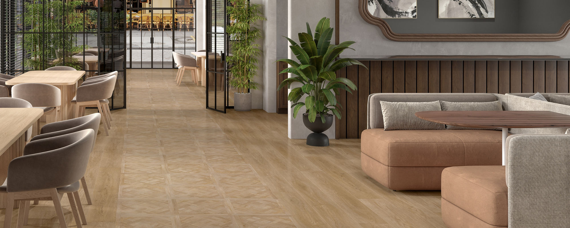 A spacious, contemporary lounge features light wood flooring and a curved wooden ceiling. The setting includes comfortable seating areas with beige and brown sofas, a dining table with chairs, and lush hanging plants. Large windows and glass doors al