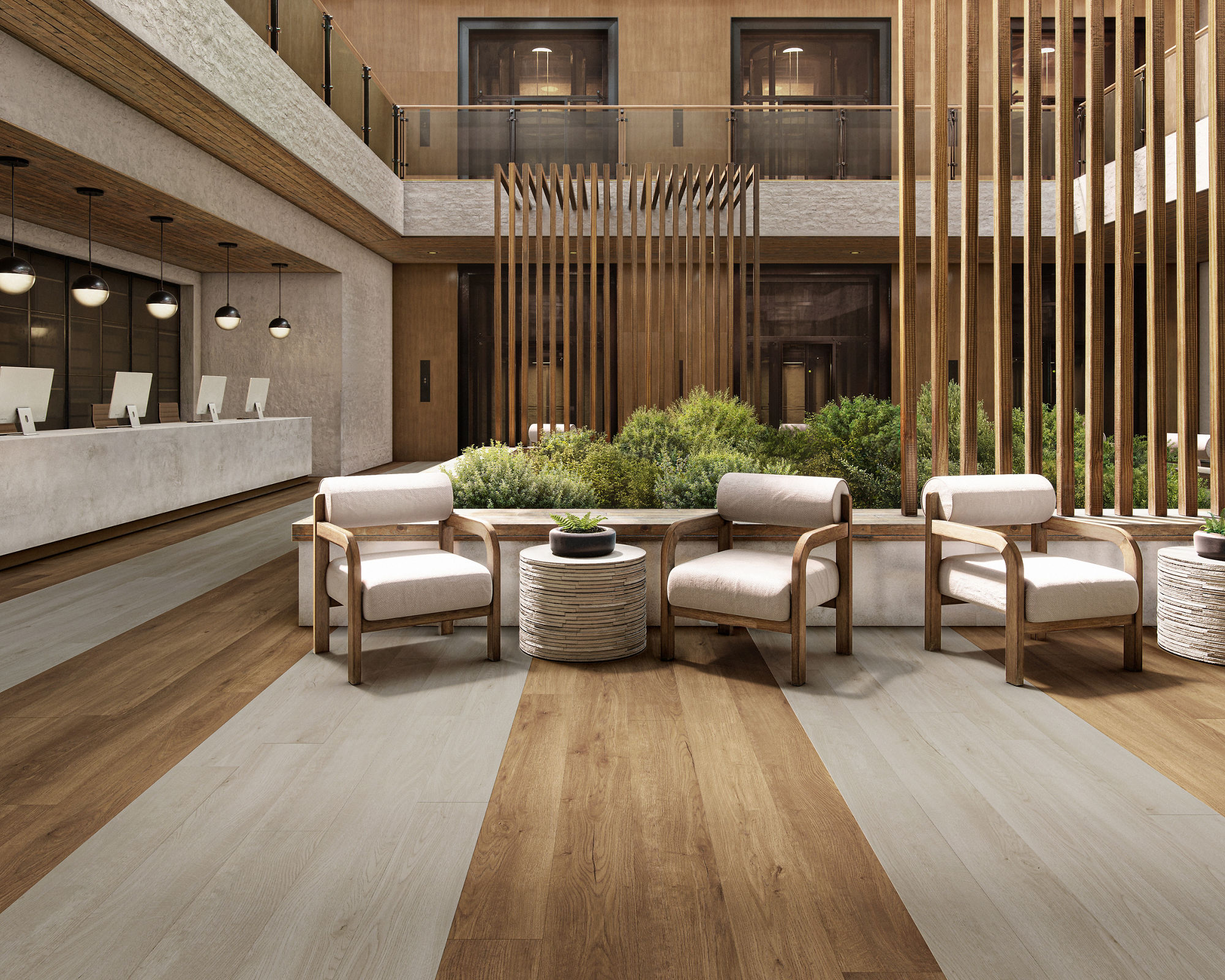 A spacious, contemporary hotel lobby features a central seating area with cushioned chairs and a round table.