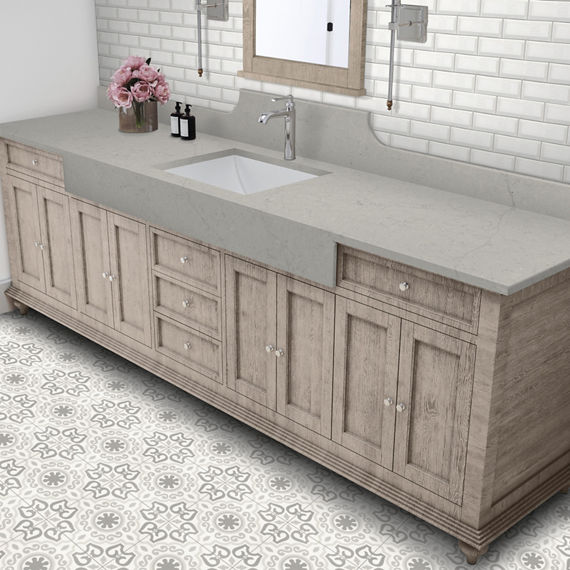Bathroom with gray stone look countertop, white subway tile on backsplash, and white encaustic  square floor tile.