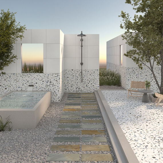 Outdoor shower with white terrazzo look walls.
