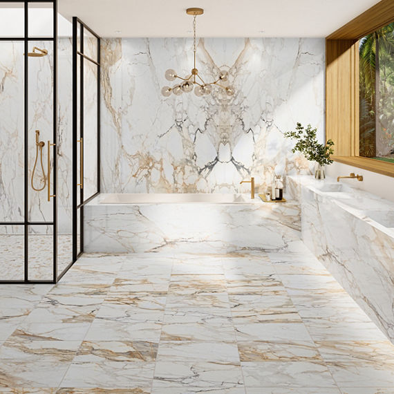 Bathroom with white marble look tile on floor and back wall, gold and black accents, and a large window showing greenery.