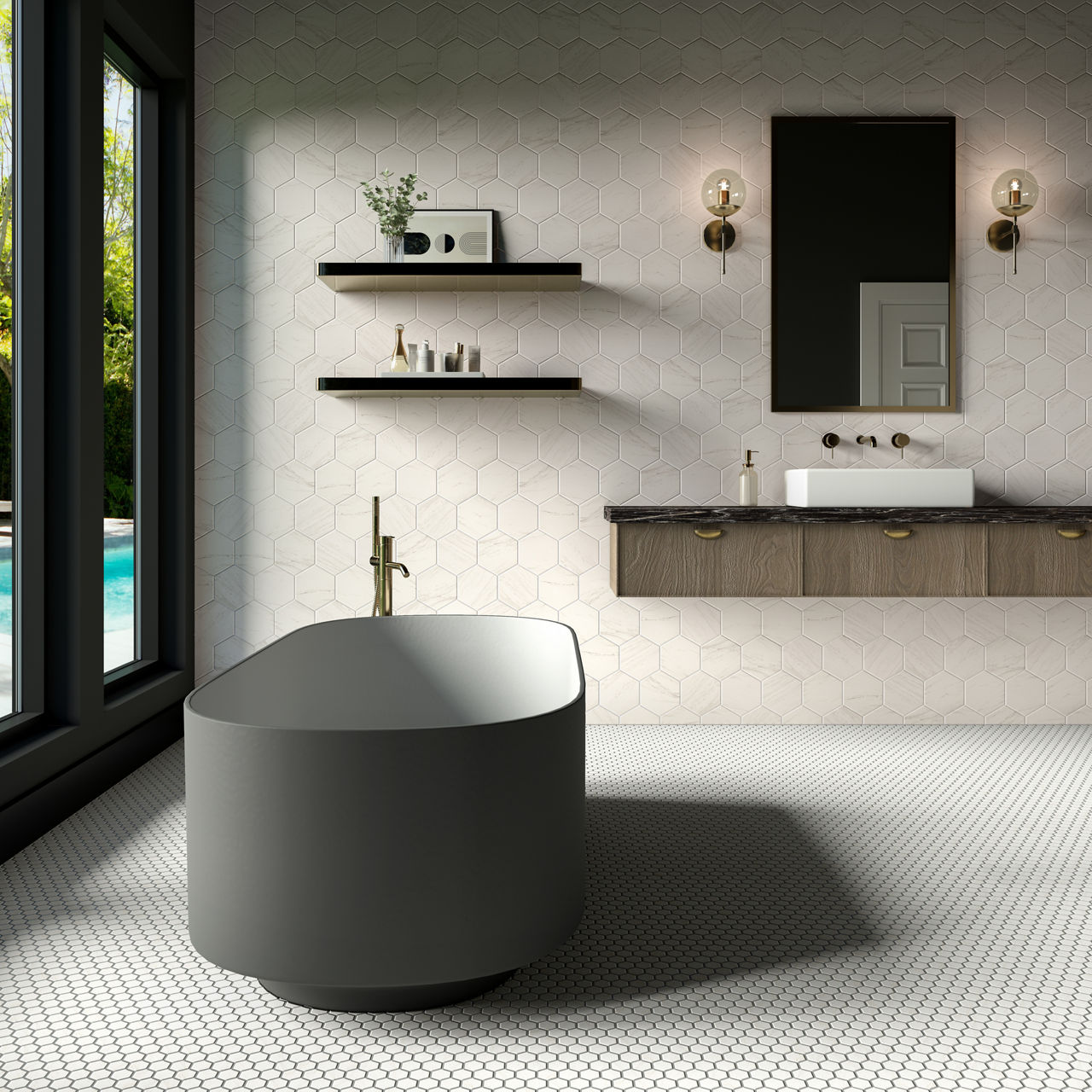 A contemporary bathroom features a sleek freestanding bathtub in the foreground. The space includes a wall-mounted vanity with a rectangular mirror and brass fixtures. Hexagonal wall tiles and small round floor tiles create a textured, geometric back