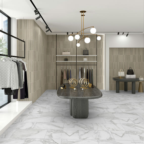 Department store with white marble look rectangle floor tile, white walls, wall niches with beige subway tile, and wooden tables displaying apparel.