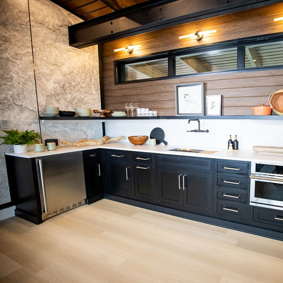 Chip Wades residential renovation, Pinhoti Peak, ADU kitchen with white quartz countertop and backsplash, natural wood shiplap, and black floating shelf.