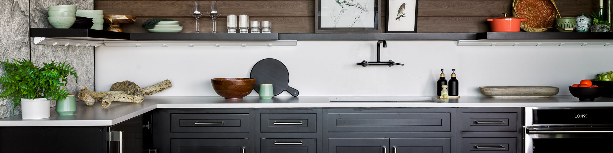 Chip Wades residential renovation, Pinhoti Peak, ADU kitchen with white quartz countertop and backsplash, natural wood shiplap, and black floating shelf.